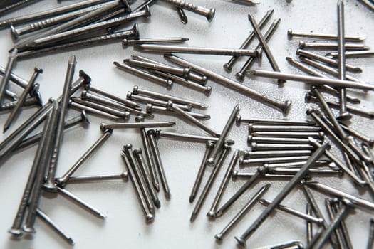 Stack of iron nails on white background