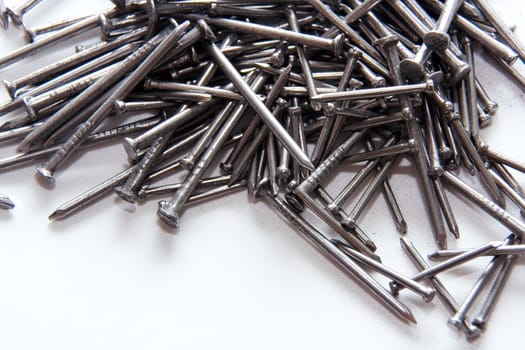 Stack of iron nails on white background