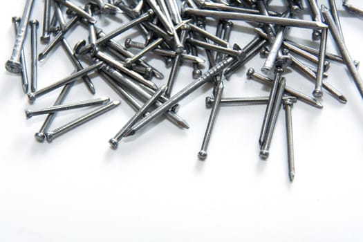 Stack of iron nails on white background