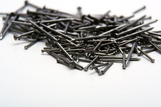 Stack of iron nails on white background