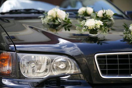 black wedding car with flowers on mask