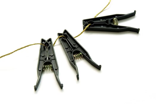 Black plastic linen clothespins on white background