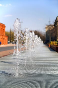 row of waterworks in front of shopping center in Lodz - Poland