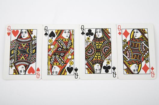four queens - playing card on light background