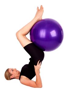 Women in yoga poise with ball on white
