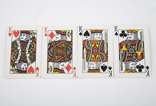 four kings - playing card on light background