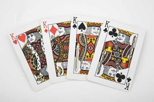 four kings - playing card on light background