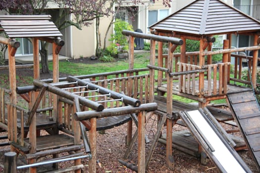 Playground equipment with stairs and climbing ropes.
