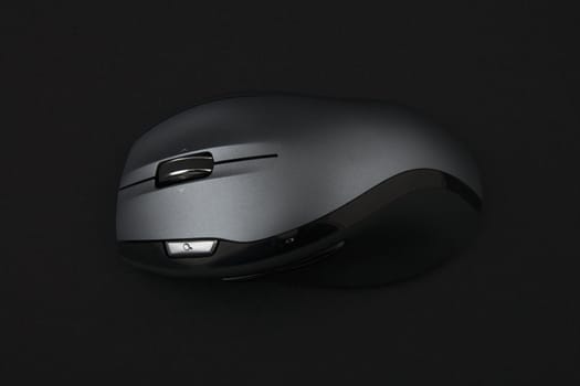cordless computer mouse on very dark background