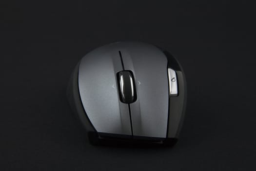 cordless computer mouse on very dark background