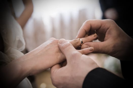 wedding ceremony - putting the ring on finger