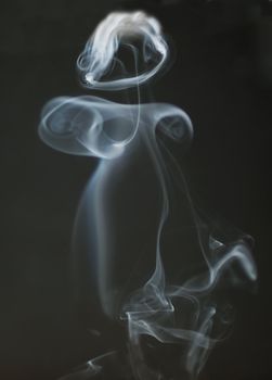 A curious curl of smoke over white background