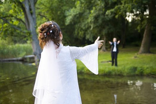 young bride drawing out her hands to her fiance