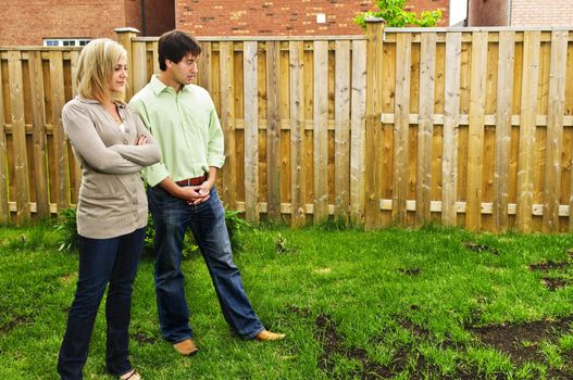 Young couple worried about growing lawn in backyard of new home