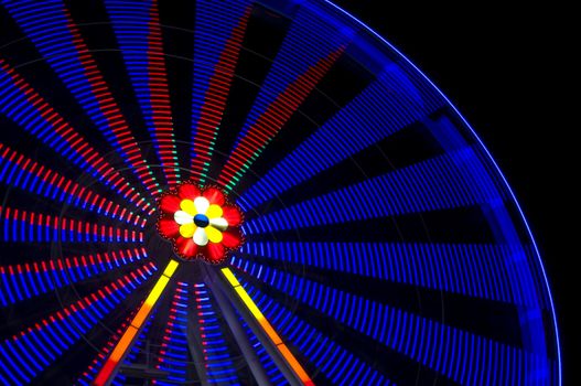 motion blur of a colorful ferris wheel at night