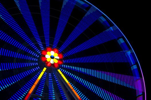 motion blur of a colorful ferris wheel at night