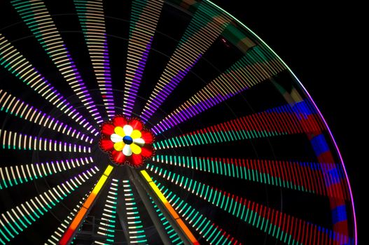 motion blur of a colorful ferris wheel at night