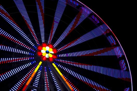 motion blur of a colorful ferris wheel at night