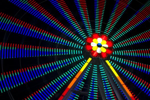 motion blur of a colorful ferris wheel at night