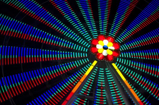 motion blur of a colorful ferris wheel at night