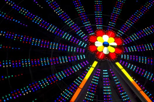 motion blur of a colorful ferris wheel at night