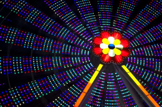 motion blur of a colorful ferris wheel at night