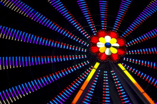 motion blur of a colorful ferris wheel at night