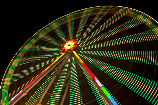 motion blur of a colorful ferris wheel at night