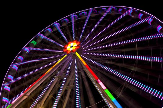 motion blur of a colorful ferris wheel at night