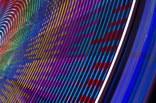 motion blur of a colorful ferris wheel at night