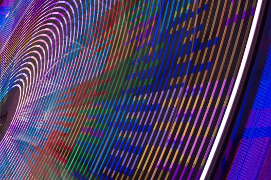motion blur of a colorful ferris wheel at night