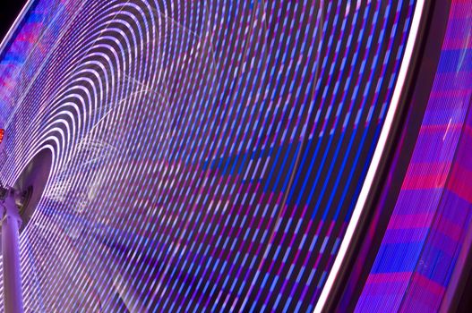motion blur of a colorful ferris wheel at night