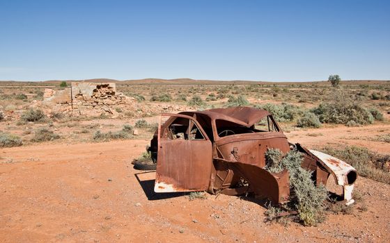 great image of an old car rusting away in the desert
