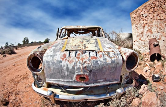 great image of an old car rusting away in the desert