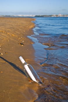 an sos message in a bottle at the beach