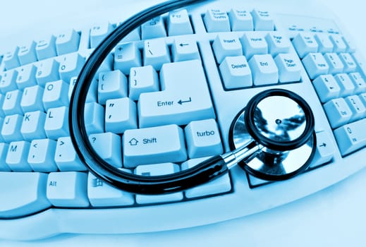 medical technology or computer problems stethoscope and keyboard on white 