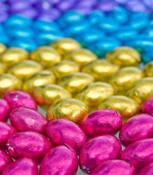 beautiful coloured chocolate easter eggs on white