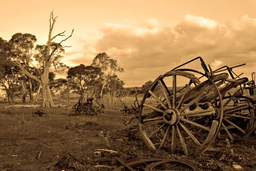 sepia image of an old cart left to rot on the farm 