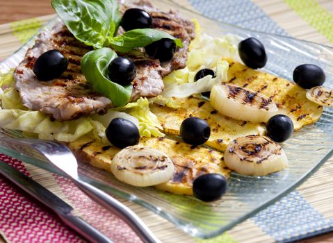 grilled pork steak with potatoes and onions