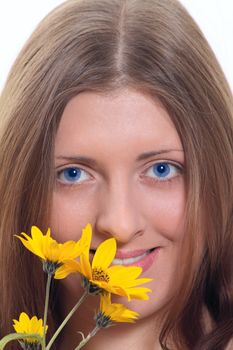 Portrait of the blue-eyed girl with a yellow wild flower removed close up