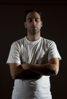 dark image of a no shaved dangerous looking guy in a rude pose