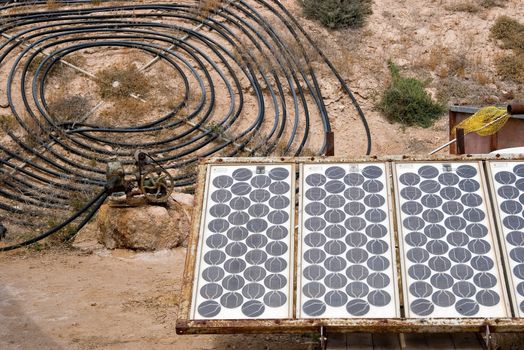 homemade solar energy sources and water heaters at an alternative energy farm using recycled materials