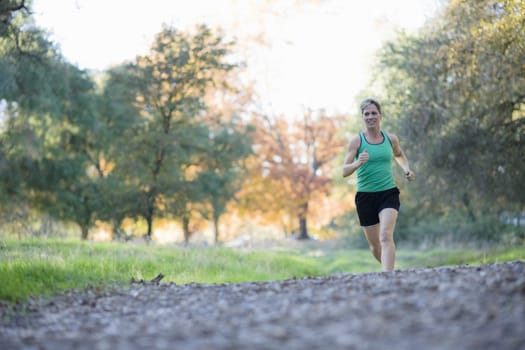 Pretty Athletic Woman Running in a Park