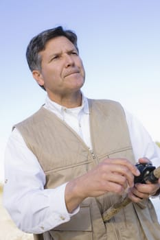 Man Standing By A River With A Fishing Pole