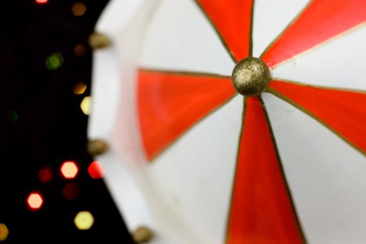 Miniature carousel with horses, against the background of New Year's lights. Depth of field for strong emotions.