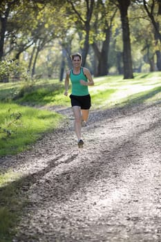 Pretty Athletic Woman Running on Path in a Park