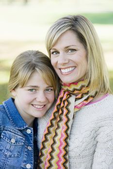 Portrait of a Mother and Daughter Standing Together in a Park