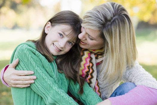 Portrait of a Mother and Daughter Sitting Together in a Park