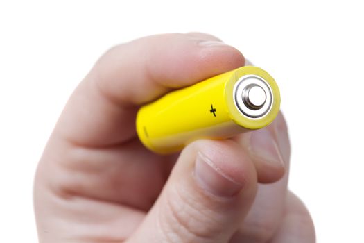 hand with an aa size battery over a white background