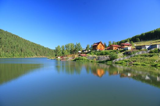 River surrounded by houses, against the blue sky 
